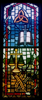 A stained glass window depicting the judgement portion of the Apostle's Creed.